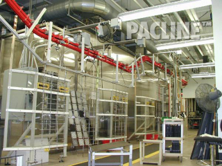 Plastics finishing of auto parts using a power and free overhead conveyor.