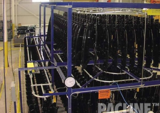 Conveyor system designed with PACLINE&#039;s enclosed track conveyor accumulates unfinished automotive parts.