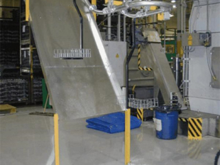 Solid guarding incorporated in overhead conveyor system to catch coolant dripping.