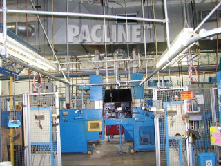 Overhead conveyor transports and accumulates automotive door seals between process.