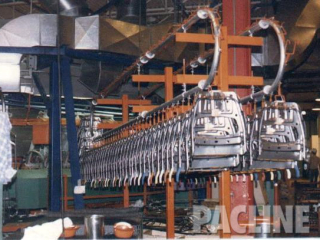 Enclosed track over and under manual conveyor used for automotive part accumulation.