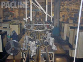 Aluminum auto parts are transferred to a variety of machining operations using PACLINE&#039;s overhead conveyor.