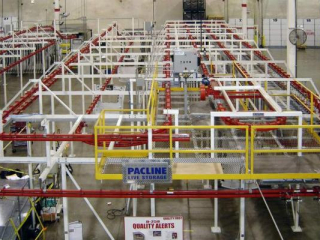 Overhead power and free conveyor system used for live storage of automotive parts.