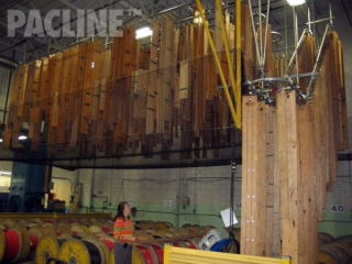 The PAC-LINE™ overhead conveyor moves long electric harness templates up in to the ceiling area for storage.