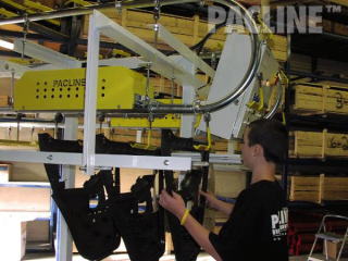 Buffer storage of paint racks with 9 inch radius curves, floor supported overhead conveyor system.