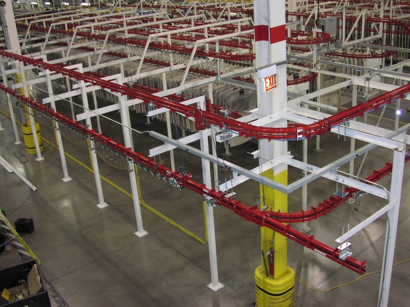 Power and free conveyor for oven curing process.