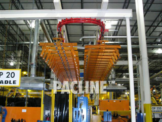 Empty carriers on conveyor system designed to transfer and accumulate engine cradles during welding process.