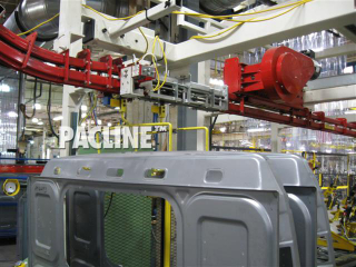 Overhead power and free conveyor for buffering truck body panels between processes.