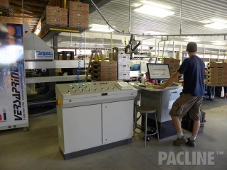 Produce sorting equipment with overhead conveyor.
