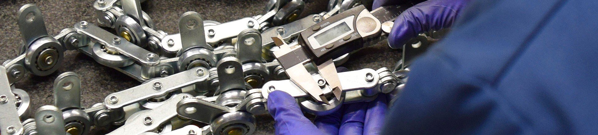 Quality testing on conveyor components quality assurance testing on overhead conveyors parts.