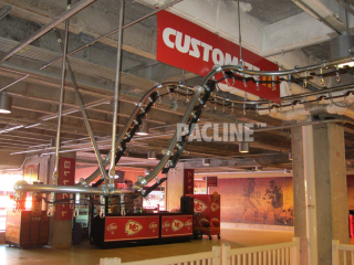 PACLINE conveyor moves clothing from floor level to ceiling level leaving floor clear of supports and equipment.