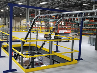 A two level conveyor system for handling empty cartons in a distribution center