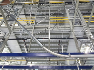 Empty carton delivery conveyor for large retailer