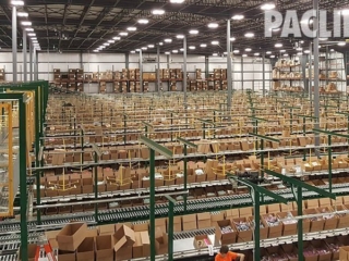 Warehouse conveyor for delivering empty cartons.