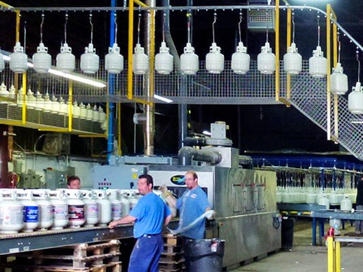 Enclosed track conveyor for wet spray paint line