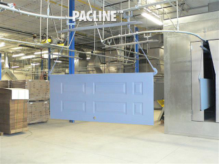 Wooden doors transferred through paint finishing line on enclosed track overhead conveyor.