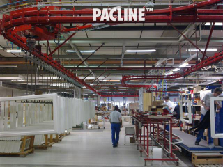 Paint finishing line for wooden doors and window frames uses power and free conveyor system.