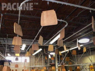 Overhead conveyor system eliminates the need for rack drying on floor. The conveyor also conserves floor space.