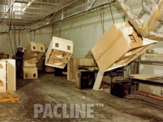 PACLINE overhead conveyor transfers large wood furniture cabinets through finishing line leaving floor space clear.