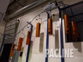 The PAC-LINE™ enclosed track overhead conveyor in a Wet Spray application, moves product into a paint oven.