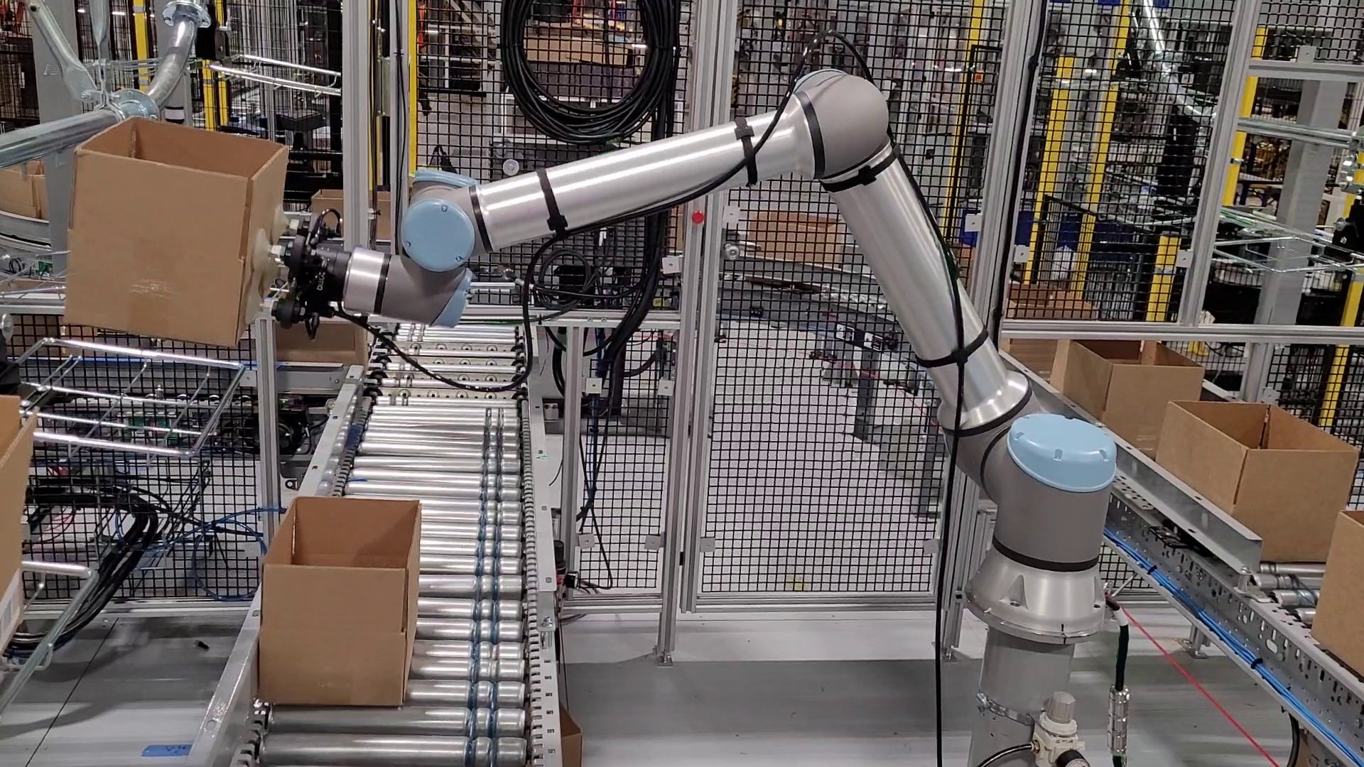 BEST-Robotic-Empty-Carton-Loading Robotic loading of empty boxes to an overhead conveyor for warehouse and distribution center solutions.